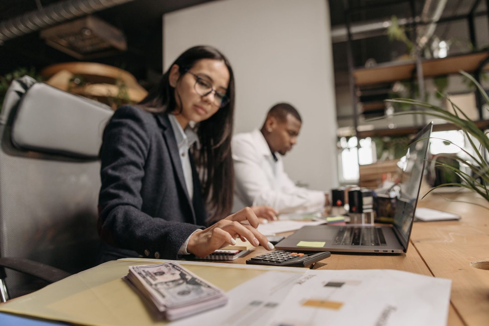 Two Keystone Ledger accountants reviewing a small business tax return together at a desk in their Cherry Hill, NJ office